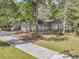 Charming single-story home with a brick facade, surrounded by mature trees and a well-manicured lawn at 106 Spring Farm Pl, Summerville, SC 29485