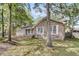 A brick home surrounded by trees, featuring a tidy lawn, and a covered front porch for relaxing outdoors at 106 Spring Farm Pl, Summerville, SC 29485