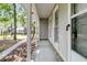 A covered front porch with brick accents and white columns creates a charming outdoor transition space at 106 Spring Farm Pl, Summerville, SC 29485