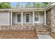 Close-up of a covered front porch with brick accents and neutral siding, offering a welcoming entrance at 106 Spring Farm Pl, Summerville, SC 29485