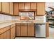 Kitchen area featuring wood cabinetry, stainless steel dishwasher, and a view of the living room at 106 Spring Farm Pl, Summerville, SC 29485