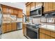 Vintage kitchen with wood cabinets, stainless steel dishwasher, and view of the living room at 106 Spring Farm Pl, Summerville, SC 29485
