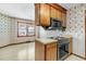 Kitchen with vintage wood cabinetry, floral wallpaper, and retro appliances at 106 Spring Farm Pl, Summerville, SC 29485