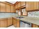 Kitchen featuring a stainless steel dishwasher, wood cabinets, and view to an adjacent space at 106 Spring Farm Pl, Summerville, SC 29485