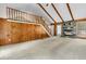 Living room featuring beamed ceilings, stone fireplace, wood paneled walls, and staircase at 106 Spring Farm Pl, Summerville, SC 29485