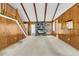 Spacious living room features a stone fireplace, wood paneled walls, and high, beamed ceilings at 106 Spring Farm Pl, Summerville, SC 29485