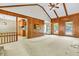 Living room with open kitchen view, wood paneled walls, beamed ceilings, and carpet flooring at 106 Spring Farm Pl, Summerville, SC 29485
