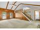 Open living room boasting wood paneled walls, carpet flooring, and a staircase to an upper level at 106 Spring Farm Pl, Summerville, SC 29485
