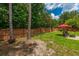 Backyard with mature trees, grassy area, and seating area at 107 Towering Pine Dr, Ladson, SC 29456