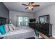 Well-lit bedroom with a ceiling fan, large window, and dark wood dresser at 107 Towering Pine Dr, Ladson, SC 29456