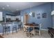 Cozy dining area with stylish lighting and a breakfast bar leading to a modern kitchen at 107 Towering Pine Dr, Ladson, SC 29456
