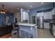 Modern kitchen with stainless steel appliances and a breakfast bar opening to living area at 107 Towering Pine Dr, Ladson, SC 29456