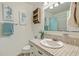 Bathroom with white sink and vanity, a tiled countertop and nautical artwork at 109 Winston Way, Goose Creek, SC 29445