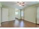 Bedroom with hardwood flooring, ceiling fan, and doorway to the bathroom at 109 Winston Way, Goose Creek, SC 29445