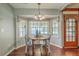 Bright dining area features a window nook with hardwood floors and stylish lighting at 109 Winston Way, Goose Creek, SC 29445