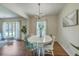 An elegant dining room features a chandelier and a bright window with seating for four at 109 Winston Way, Goose Creek, SC 29445