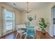 Cozy dining room with a modern chandelier and a view of the outdoors through a bright window at 109 Winston Way, Goose Creek, SC 29445