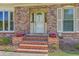 A welcoming entrance features brick steps and colorful potted plants, enhancing curb appeal at 109 Winston Way, Goose Creek, SC 29445