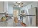 Bright kitchen boasts stainless steel appliances, granite countertops, and white cabinetry with hardwood floors at 109 Winston Way, Goose Creek, SC 29445