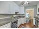 Cozy kitchen featuring white cabinets, dark countertops, stainless steel appliances, and hardwood floors at 109 Winston Way, Goose Creek, SC 29445
