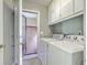 Laundry room with washer, dryer, shelving and access to the backyard at 109 Winston Way, Goose Creek, SC 29445