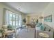 Comfortable living room with large bright window and stylish decor open to dining room at 109 Winston Way, Goose Creek, SC 29445