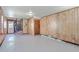 Open concept living room with wood paneling and neutral paint at 109 Winston Way, Goose Creek, SC 29445