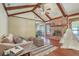 Bright living room featuring hardwood floors, exposed beams, and a cozy brick fireplace at 109 Winston Way, Goose Creek, SC 29445