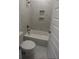 Bathroom featuring a sleek white bathtub, marble tiling, and built-in shelving at 113 Seaton St, Summerville, SC 29486