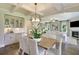 Dining and living rooms are bathed in natural light, featuring hardwood floors and fireplace at 115 Seaton St, Summerville, SC 29486