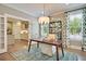 Dining room with wood table, decorative rug, and lots of natural light from windows, open to kitchen at 115 Seaton St, Summerville, SC 29486