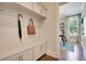 Mud room entryway with hooks, bench seating, and storage cabinets, with access to the office at 115 Seaton St, Summerville, SC 29486