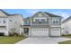 Charming two-story home featuring a gray exterior, attached two-car garage, and well-maintained front lawn at 115 Seaton St, Summerville, SC 29486
