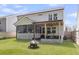 Backyard featuring a screened porch, pergola with grill, wood fence, and lush green lawn at 1167 Mossy Rock Dr, Summerville, SC 29485