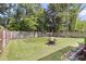 Spacious backyard featuring a well-maintained lawn, a fire pit, and a wood fence providing privacy at 1167 Mossy Rock Dr, Summerville, SC 29485