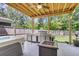Spacious outdoor space with a full kitchen, firepit, and jacuzzi at 1167 Mossy Rock Dr, Summerville, SC 29485