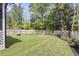 Spacious backyard featuring a well-maintained lawn, a fire pit, and a wood fence providing privacy at 1167 Mossy Rock Dr, Summerville, SC 29485