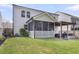 Backyard featuring a screened porch, pergola with grill, wood fence, and lush green lawn at 1167 Mossy Rock Dr, Summerville, SC 29485