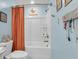 Bathroom features a shower-tub with a shower curtain and a commode with a jar of seashells on the tank at 1167 Mossy Rock Dr, Summerville, SC 29485