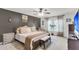 Neutral Primary bedroom suite features a ceiling fan, ensuite access, large windows and seating area at 1167 Mossy Rock Dr, Summerville, SC 29485