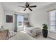 Bright bedroom with a ceiling fan, two windows, decorative wall art, and cozy decor at 1167 Mossy Rock Dr, Summerville, SC 29485