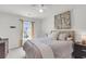 Bright bedroom with a neutral color palette, large window, ceiling fan, and a cozy upholstered bed at 1167 Mossy Rock Dr, Summerville, SC 29485