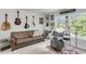 Upstairs bonus room is a music room with a couch, a drum set, posters, and natural light from multiple windows at 1167 Mossy Rock Dr, Summerville, SC 29485