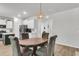 Dining area featuring a wooden table with four chairs and a decorative light fixture at 1167 Mossy Rock Dr, Summerville, SC 29485