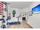 Home gym with exercise equipment, including a treadmill, weight rack, and a TV with a beach scene at 1167 Mossy Rock Dr, Summerville, SC 29485