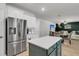 Open kitchen featuring stainless steel appliances, white cabinetry, a center island, and dining area beyond at 1167 Mossy Rock Dr, Summerville, SC 29485