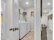 Bright laundry room features a side-by-side washer and dryer with wire shelving above for storage at 1167 Mossy Rock Dr, Summerville, SC 29485