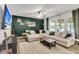 Bright living room with a large sectional couch, natural light, and backyard views, perfect for relaxing and entertaining at 1167 Mossy Rock Dr, Summerville, SC 29485