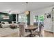 Open-concept living room featuring stylish furniture, a decorative light fixture, and sliding glass doors to patio at 1167 Mossy Rock Dr, Summerville, SC 29485