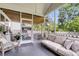 Comfortable seating area on a screened porch with a view of the backyard at 1167 Mossy Rock Dr, Summerville, SC 29485